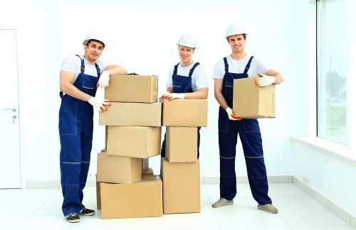 Worker assessing lifting risks before moving boxes