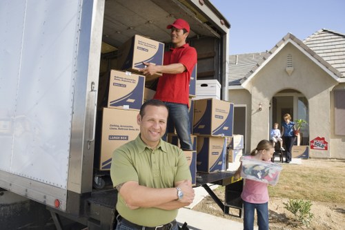 House movers handling furniture and packed boxes in a residential move