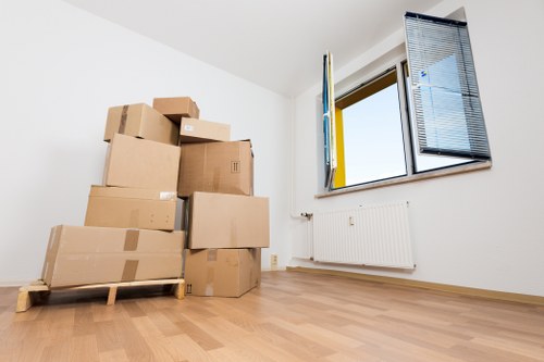 Boxes and furniture being loaded into a local moving van