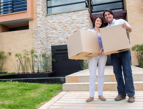 Mover carrying boxes during a local house removal